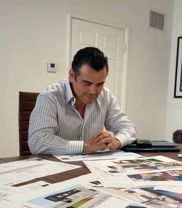 Andrew Robles reviewing project plans and design materials